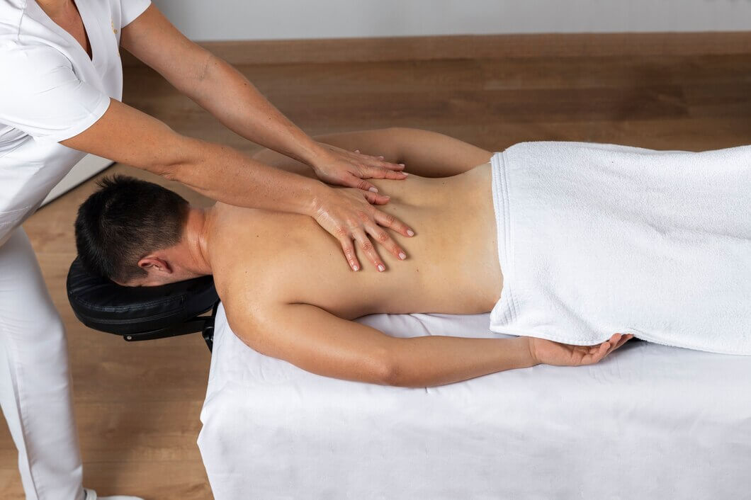 man receiving massage physiotherapy session_23 2149143818